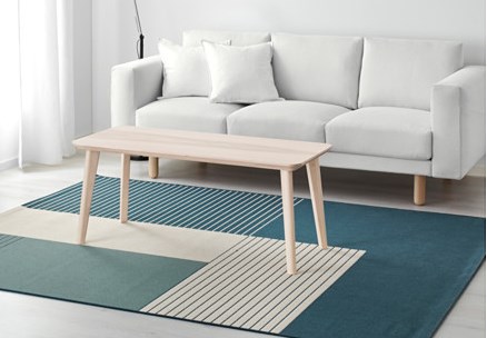 white and blue rug in a living room with graphic pattern