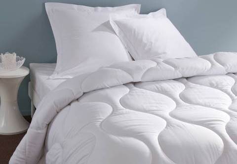 White comforter with pillows on a bed