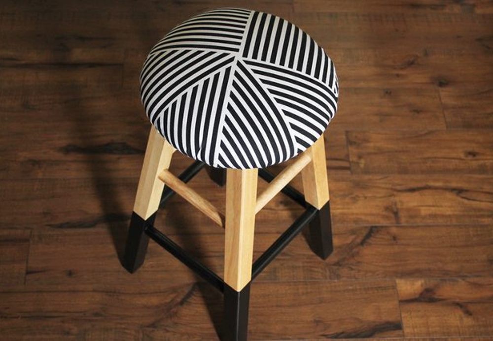 Bar stools makeover with black paint and white and black fabric