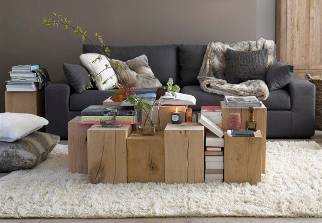 Wooden tables in front of a grey sofa