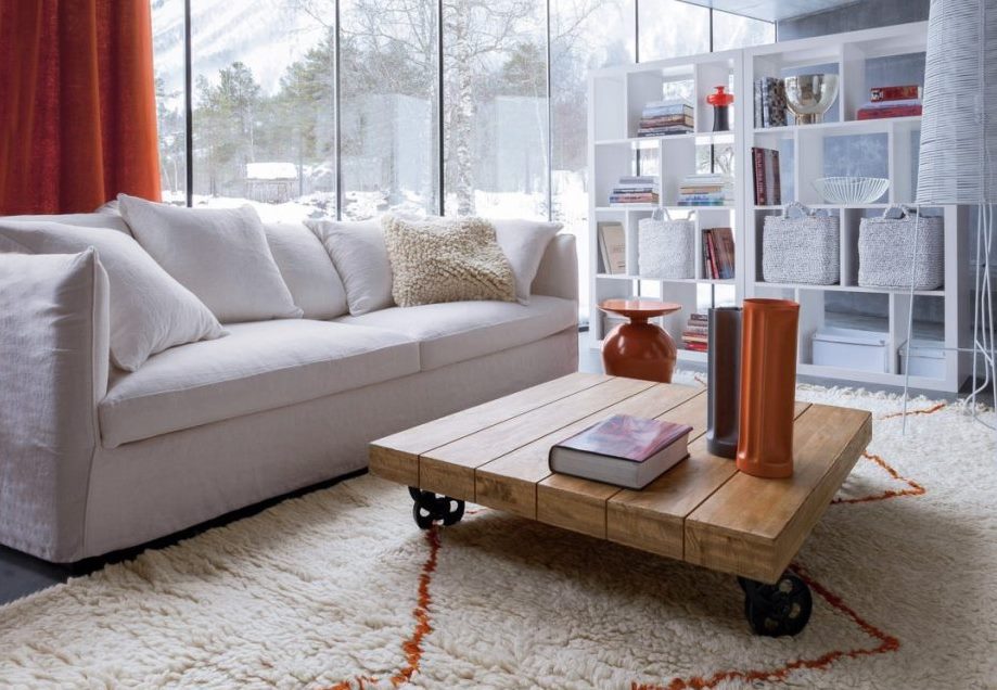 White couch with orange curtains in a cosy atmosphere