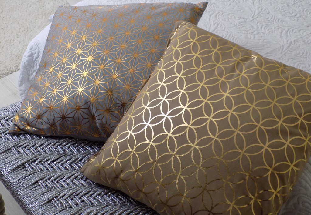 Two brown cushions with golden patterns