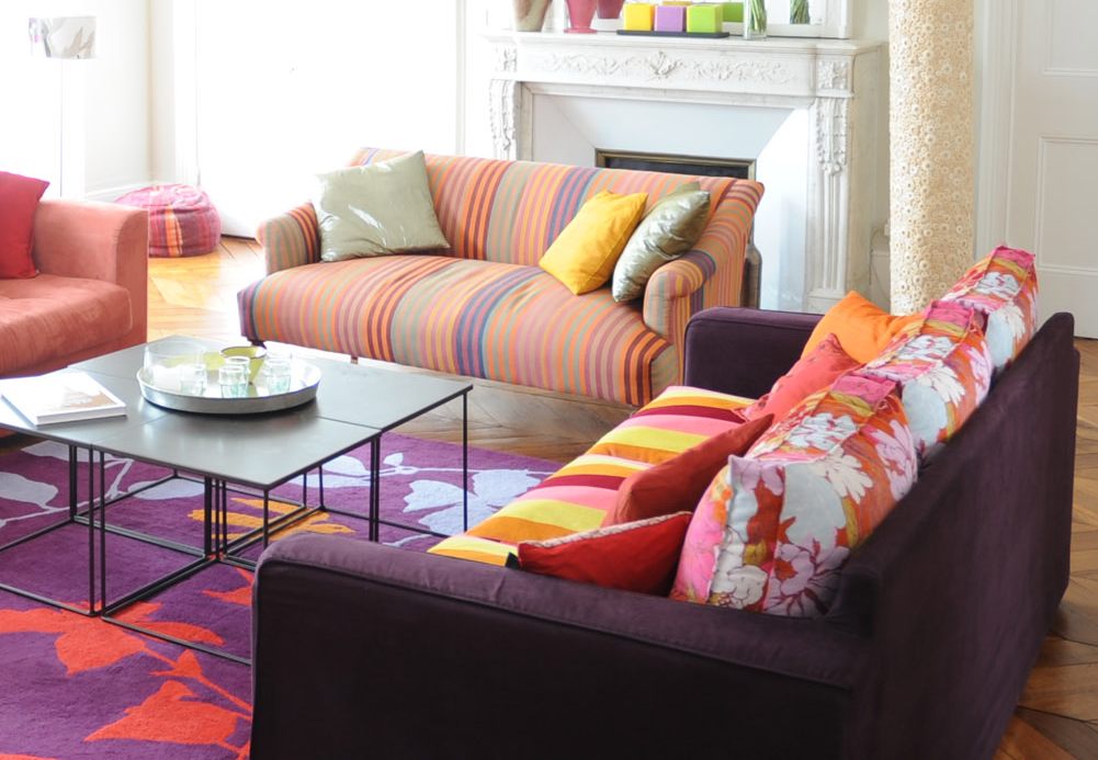 Mixing patterns by style in a living room with stripes and floral designs