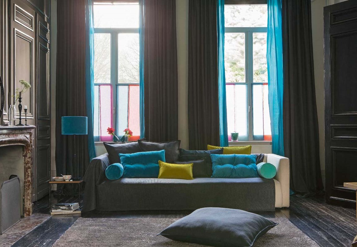 Dark living room with colored curtains and cushions