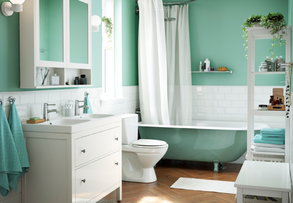 Ikea bathroom with green wall and white furniture