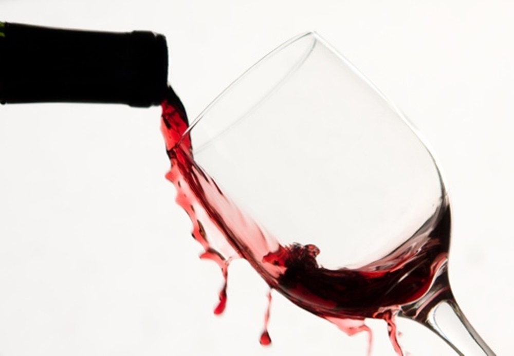 Bottle pouring red wine in a glass